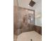 Walk-in shower tiled in marbled stone with frameless glass and mosaic-tiled floor at 24548 N 121St Pl, Scottsdale, AZ 85255