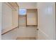 Bright walk-in closet has custom storage shelving and built-in window for natural light at 24548 N 121St Pl, Scottsdale, AZ 85255