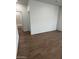 Bright bedroom with wood-look tile flooring and ample natural light at 25430 W Graham Trl, Buckeye, AZ 85326