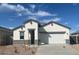 Charming single-story home featuring a two-car garage, neutral paint, and a well-manicured front yard at 25430 W Graham Trl, Buckeye, AZ 85326