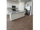 Modern kitchen featuring white cabinets, stainless steel appliances, and a center island at 25430 W Graham Trl, Buckeye, AZ 85326