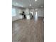 Open-concept living area showcasing wood-look tile flooring and a modern kitchen at 25430 W Graham Trl, Buckeye, AZ 85326