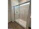 Bathroom featuring a sleek glass-enclosed shower with marble-style surround at 25430 W Graham Trl, Buckeye, AZ 85326