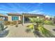 Backyard featuring a covered patio, desert landscaping, cactus, pavers and drought-tolerant plants at 26439 W Covey Ln, Buckeye, AZ 85396