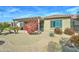 Backyard featuring a covered patio, lush bushes, pavers, and drought-tolerant landscaping at 26439 W Covey Ln, Buckeye, AZ 85396