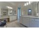 Luxurious bathroom featuring double vanities, a makeup area, granite countertops, and framed mirrors at 26439 W Covey Ln, Buckeye, AZ 85396