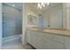 Bright bathroom featuring white cabinets, countertops, and a glass shower at 26439 W Covey Ln, Buckeye, AZ 85396
