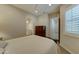 Comfortable bedroom with a wooden dresser and a bathroom en suite at 26439 W Covey Ln, Buckeye, AZ 85396
