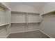Walk-in closet with a custom shelving and hanging system for organized storage at 26439 W Covey Ln, Buckeye, AZ 85396