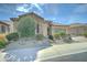 Beautifully landscaped single-story home with stone accents and a well-maintained front yard at 26439 W Covey Ln, Buckeye, AZ 85396