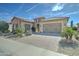 Attractive single-Gathering home with a paver driveway, desert landscaping, and a two-car garage at 26439 W Covey Ln, Buckeye, AZ 85396