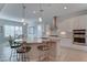 Open kitchen with a granite island, modern lighting, and seating, perfect for entertaining at 26439 W Covey Ln, Buckeye, AZ 85396