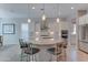 Spacious kitchen featuring a large granite island, modern appliances, and stylish pendant lighting at 26439 W Covey Ln, Buckeye, AZ 85396
