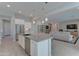 Well-lit kitchen with a stainless steel dishwasher, island seating, and an open layout at 26439 W Covey Ln, Buckeye, AZ 85396