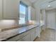 Bright office space with granite countertops, white cabinetry, and natural light at 26439 W Covey Ln, Buckeye, AZ 85396