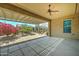 An outdoor covered patio featuring a ceiling fan, desert landscaping, and a window at 26439 W Covey Ln, Buckeye, AZ 85396