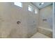 Modern shower with beige tile, a built-in seat, multiple shower heads, and a niche at 26439 W Covey Ln, Buckeye, AZ 85396