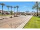 Gated community entrance with palm trees and well-maintained landscaping at 3131 E Legacy Dr # 1104, Phoenix, AZ 85042