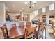 Open-concept living space with a dining table and a view of the kitchen, living area, and staircase at 3131 E Legacy Dr # 1104, Phoenix, AZ 85042