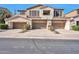 Three-car garage townhome showcasing an appealing neutral exterior with individual balconies and well-manicured landscaping at 3131 E Legacy Dr # 1104, Phoenix, AZ 85042