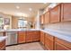 Kitchen with stainless steel appliances, wood cabinets, white countertops, and an adjacent dining area with lots of light at 3131 E Legacy Dr # 1104, Phoenix, AZ 85042