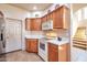 Bright kitchen featuring light wood cabinets, white countertops, and stainless steel appliances and staircase at 3131 E Legacy Dr # 1104, Phoenix, AZ 85042