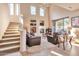 Spacious living room with a fireplace, high ceilings, plenty of natural light, and a staircase at 3131 E Legacy Dr # 1104, Phoenix, AZ 85042