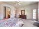 Bright bedroom with a king bed, dresser, private door to a patio, and ensuite bathroom at 3131 E Legacy Dr # 1104, Phoenix, AZ 85042
