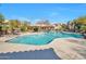 Inviting community pool area surrounded by lounge chairs and lush landscaping at 3131 E Legacy Dr # 1104, Phoenix, AZ 85042