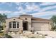Charming single-story home featuring a desert landscape, arched windows, and a spacious two-car garage at 32970 N 131St Dr, Peoria, AZ 85383