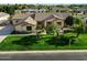 Charming single-story home featuring a tile roof, mature landscaping, and a green lawn at 3531 E Norwood Cir, Mesa, AZ 85213