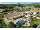 An aerial view of a backyard pool and spa, with a covered patio and desert landscaping, in a residential area at 3531 E Norwood Cir, Mesa, AZ 85213