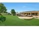 Lush backyard with a refreshing spa and covered patio, ideal for outdoor entertaining and relaxation at 3531 E Norwood Cir, Mesa, AZ 85213