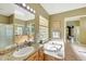Bathroom featuring dual vanities, granite countertop, garden tub, and decorative light fixture at 3531 E Norwood Cir, Mesa, AZ 85213