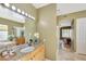 Elegant bathroom with granite counters, light wood cabinets, and decorative vanity lights at 3531 E Norwood Cir, Mesa, AZ 85213