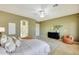 Large bedroom with travertine tile flooring, walk in closet, and ensuite bath at 3531 E Norwood Cir, Mesa, AZ 85213