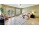Spacious bedroom with double doors to backyard, neutral paint, and travertine tile flooring at 3531 E Norwood Cir, Mesa, AZ 85213