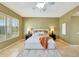 Neutral bedroom featuring tile flooring, ceiling fan, and ensuite bath at 3531 E Norwood Cir, Mesa, AZ 85213