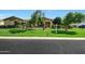 Beautiful single-story home with well-maintained landscaping, mature trees and green lawn at 3531 E Norwood Cir, Mesa, AZ 85213