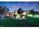 Beautiful home with mature trees, lush lawn, and landscape lighting at 3531 E Norwood Cir, Mesa, AZ 85213