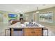 Open kitchen island with granite countertops, stainless steel appliances, and seamless flow into the living area at 3531 E Norwood Cir, Mesa, AZ 85213