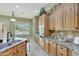 Kitchen with wood cabinets, stainless steel appliances, granite countertops, and a view of the sparkling pool at 3531 E Norwood Cir, Mesa, AZ 85213