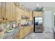Close up of bright kitchen with stainless appliances, granite counters, and lots of cabinets at 3531 E Norwood Cir, Mesa, AZ 85213