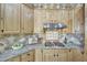 Gourmet kitchen features granite counters, decorative tile backsplash, and stainless steel gas cooktop at 3531 E Norwood Cir, Mesa, AZ 85213
