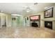 Bright living room boasts a fireplace, tile flooring, and a glass-enclosed room for an airy feel at 3531 E Norwood Cir, Mesa, AZ 85213