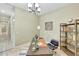 Home office with stylish decor, travertine floors, and ample natural light at 3531 E Norwood Cir, Mesa, AZ 85213