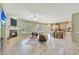 Open-concept living space with travertine floors, fireplace, and bright kitchen at 3531 E Norwood Cir, Mesa, AZ 85213