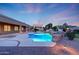 Lush backyard features a pristine pool, spa, outdoor bar, and a covered patio, creating an entertainer's paradise at 3531 E Norwood Cir, Mesa, AZ 85213