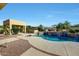 Backyard oasis featuring a custom pool with waterfall feature and desert landscaping at 3531 E Norwood Cir, Mesa, AZ 85213