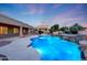 Backyard pool featuring custom waterfall feature, desert landscaping, and adjacent covered structure at 3531 E Norwood Cir, Mesa, AZ 85213